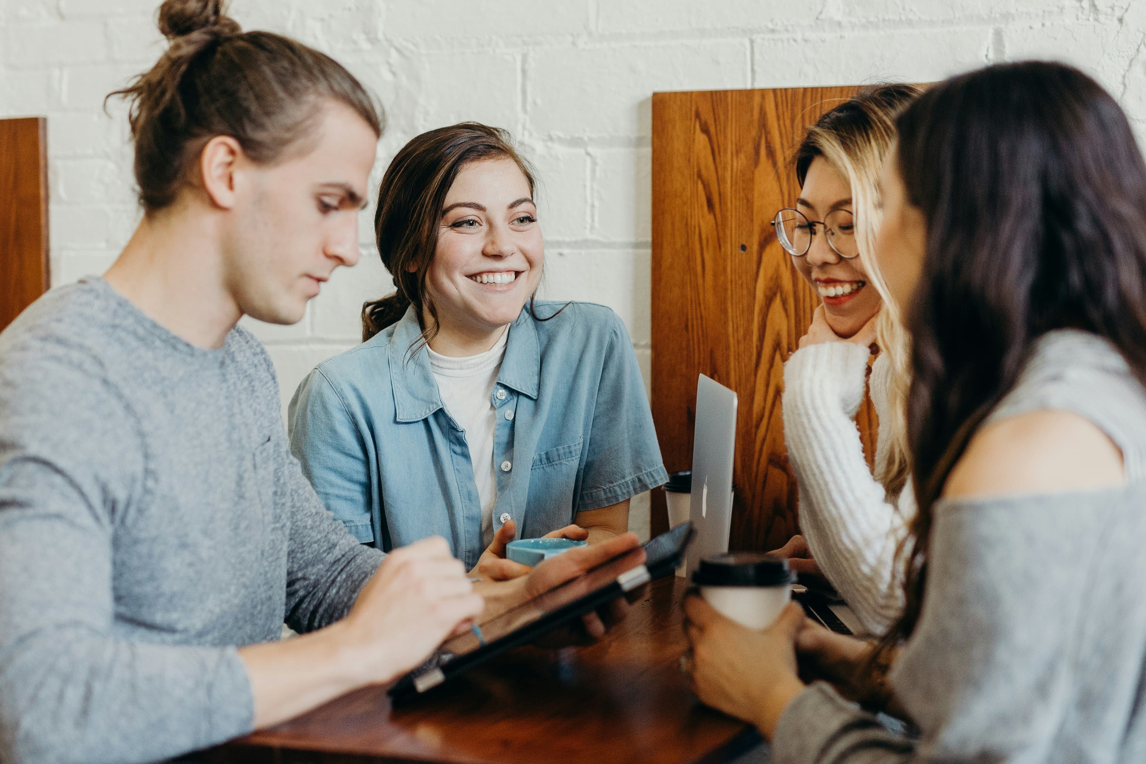 A team collaborating around a laptop